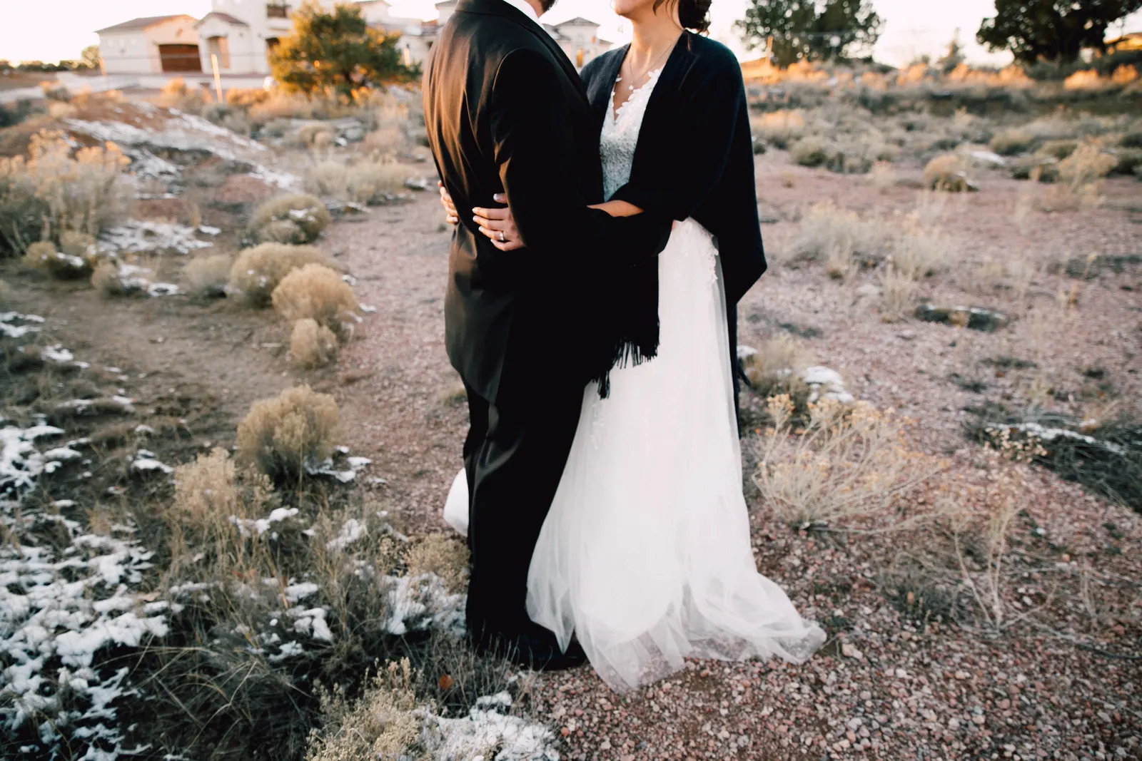 Bride and groom in a high desert at sunset